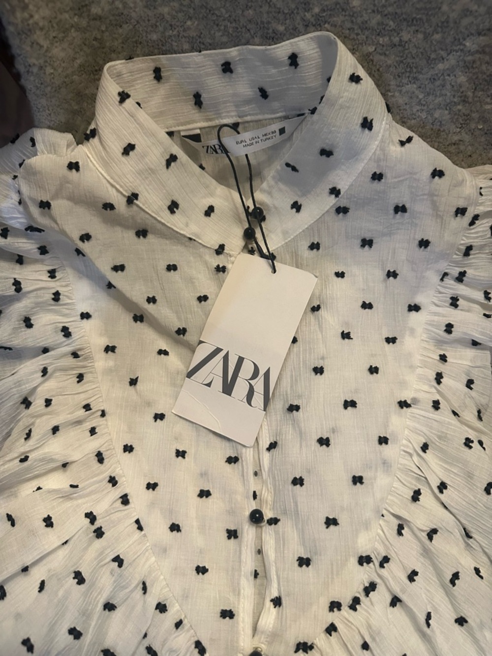 New Zara White Blouse with Black Dot Embroidery and Ruffled Shoulders.